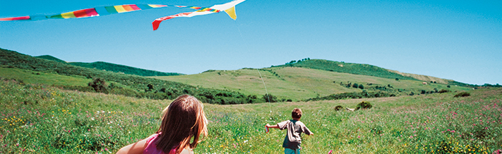 Girl and boy flying a kite