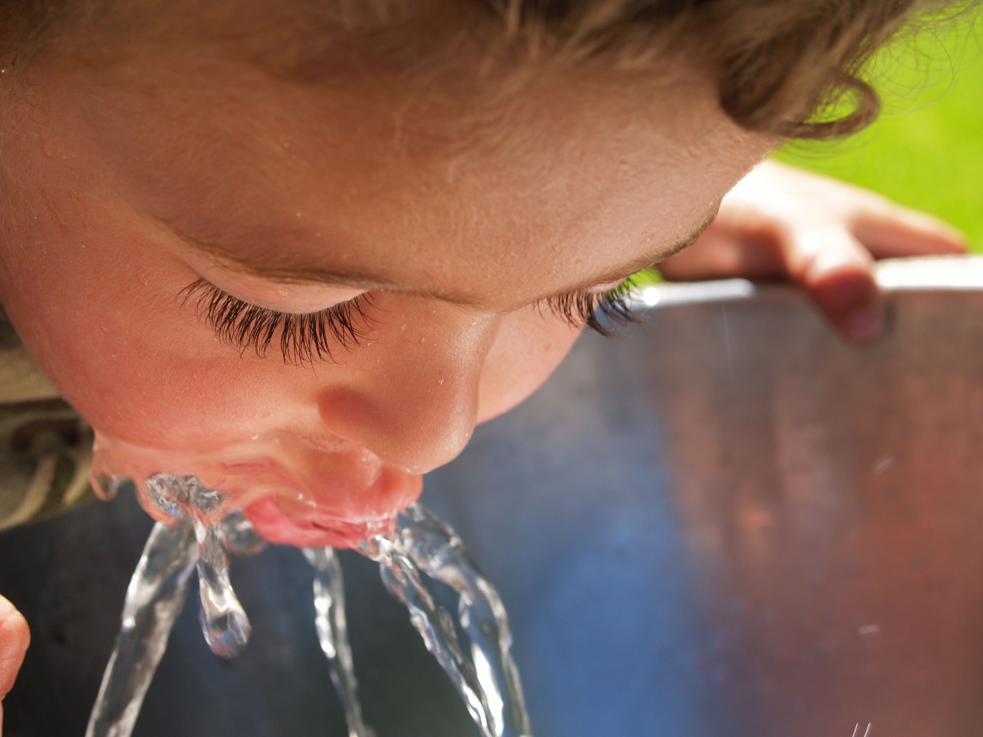 Child drinking from water fountain