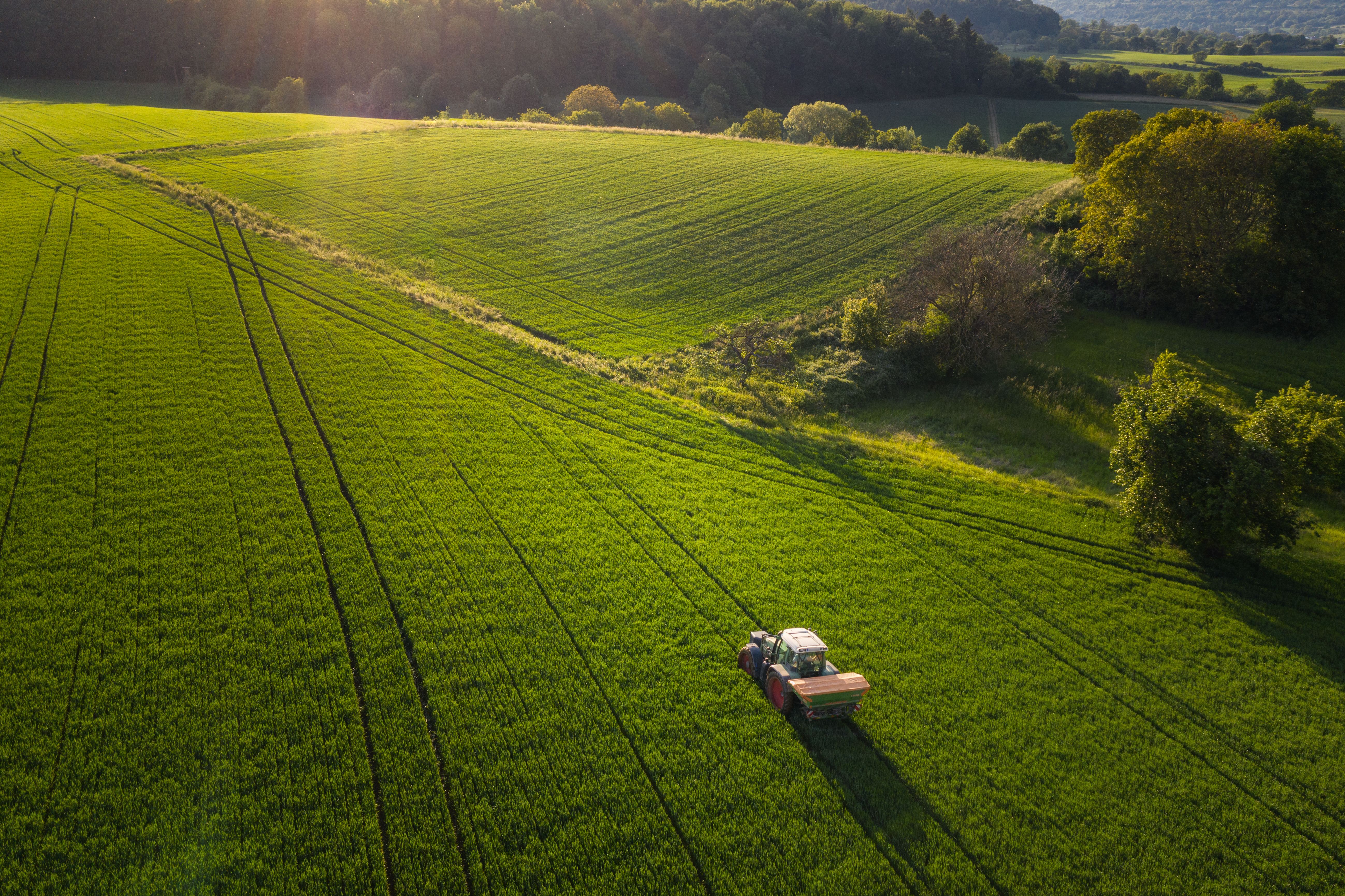 Tractor driving across farm field