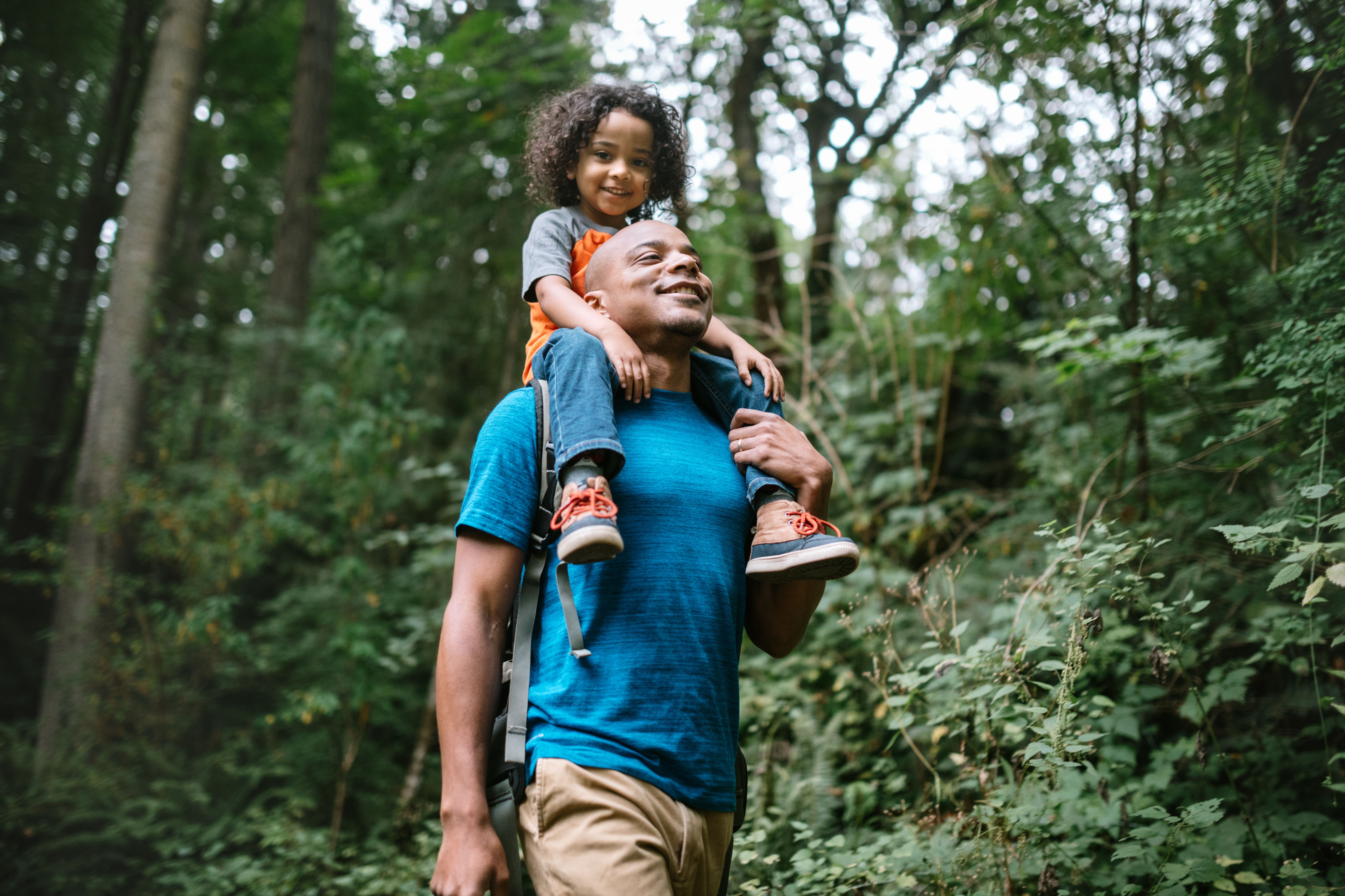 Man with child on his shoulders, both smiling