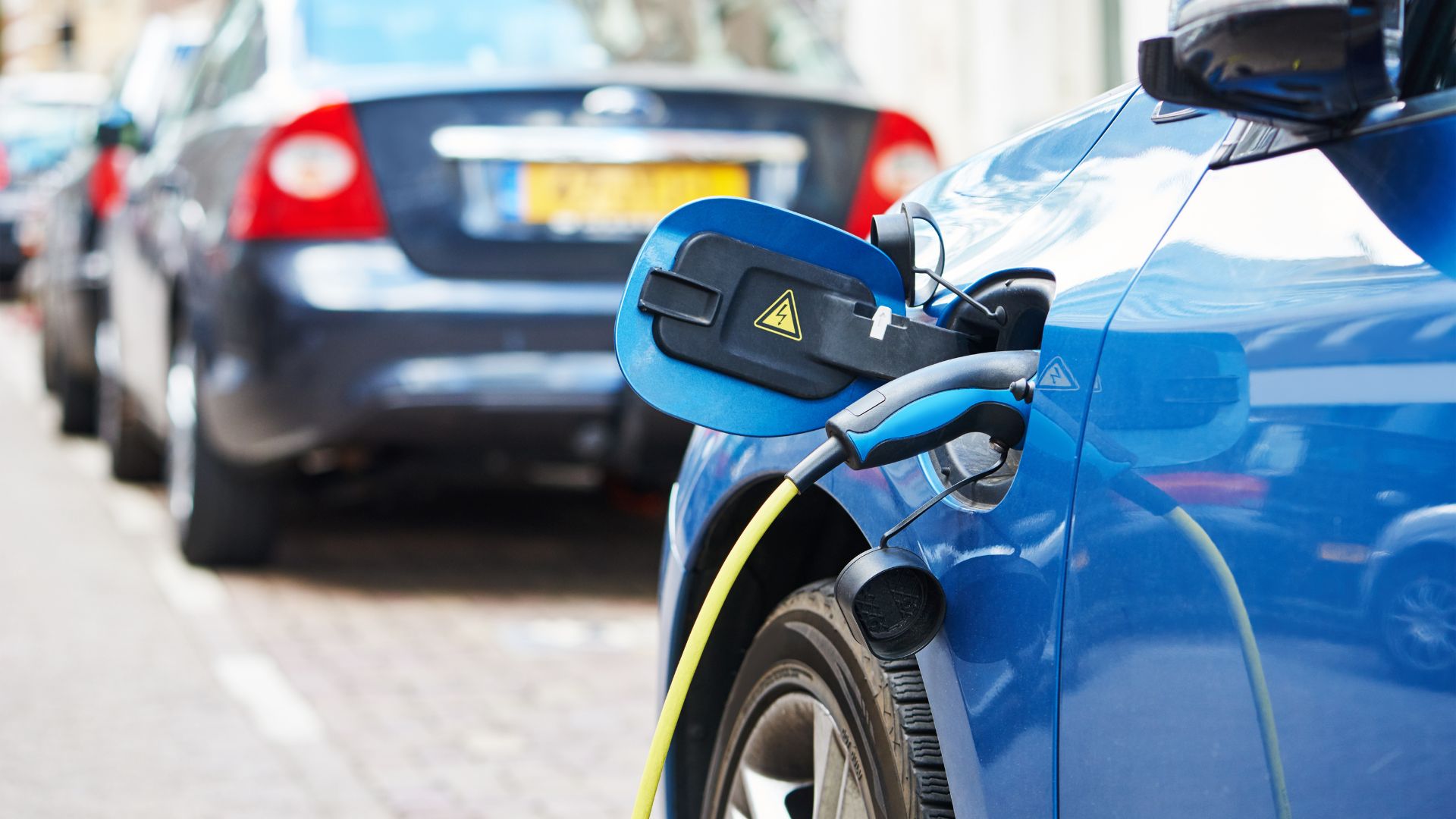 An electric car charging on the street