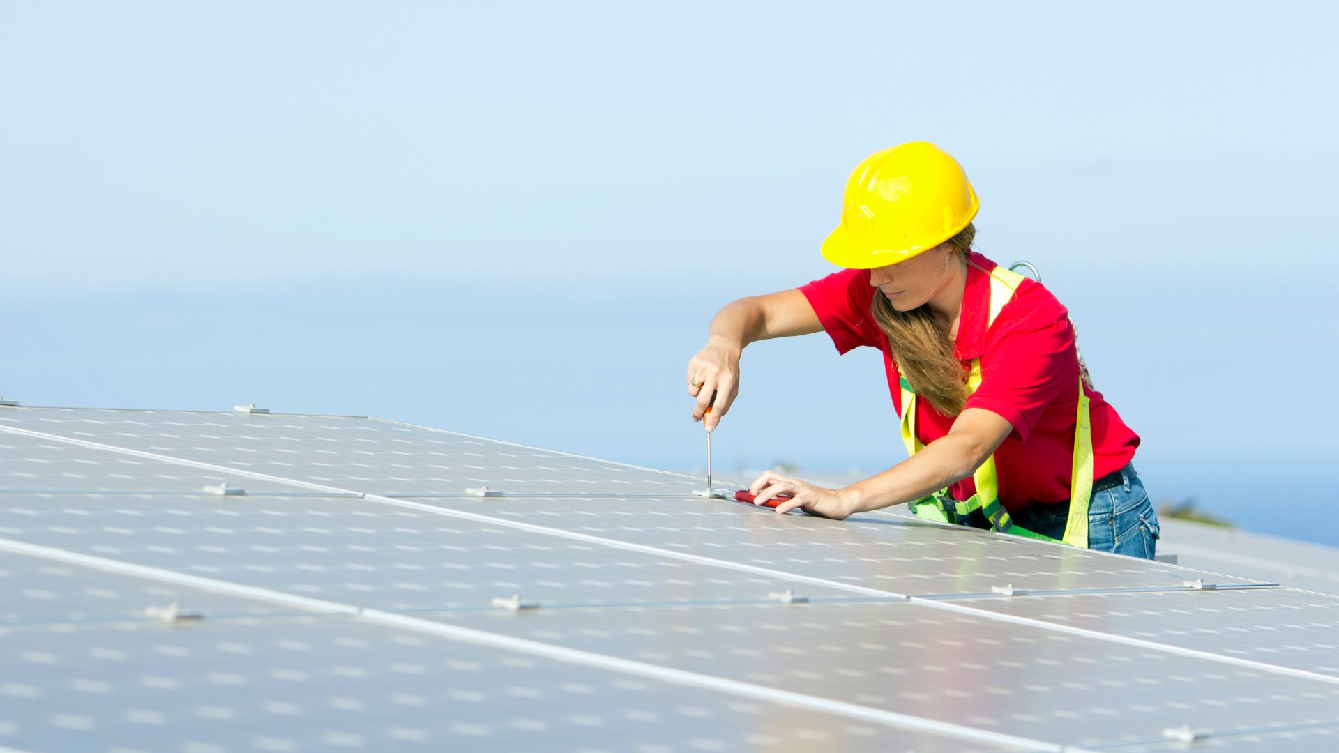 A worker installing a solar panel