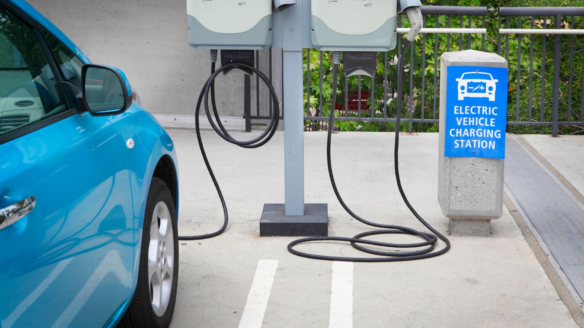 An electric car charging at a charging station
