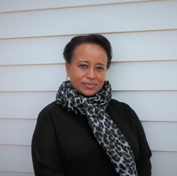 Photo of Angela Churie Kallhauge standing against a white background