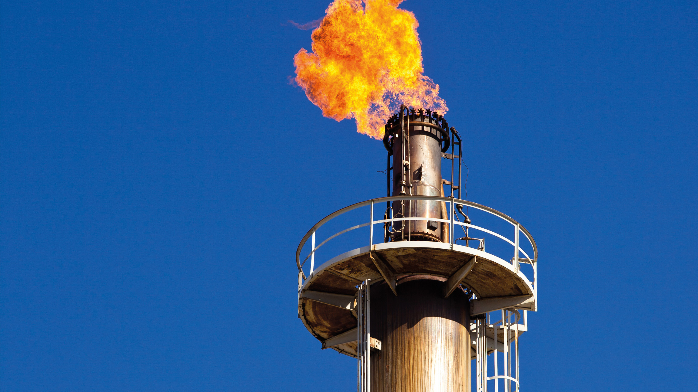 Methane flare on a smokestack