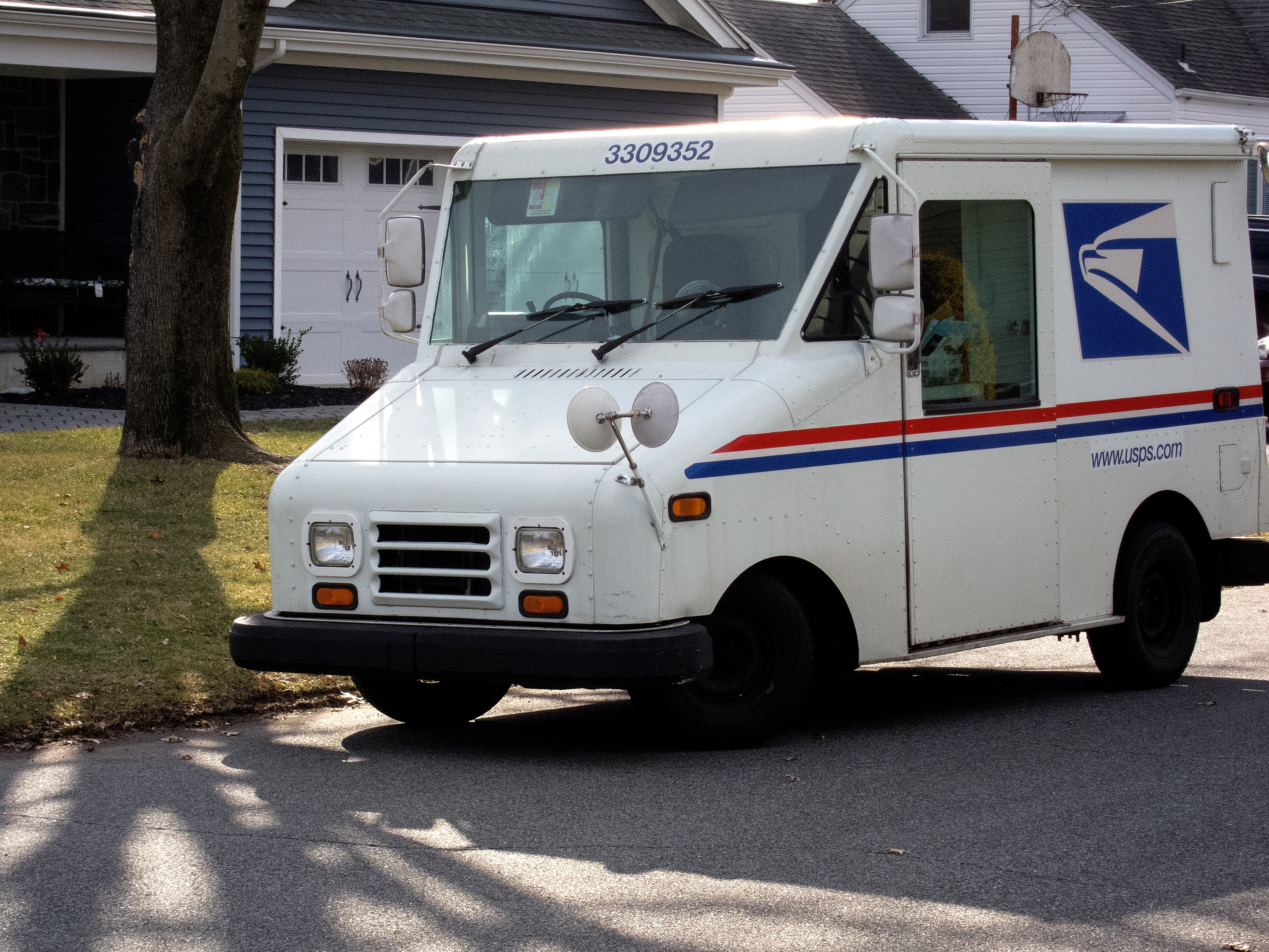 A postal delivery truck but not one of the cool new electric ones