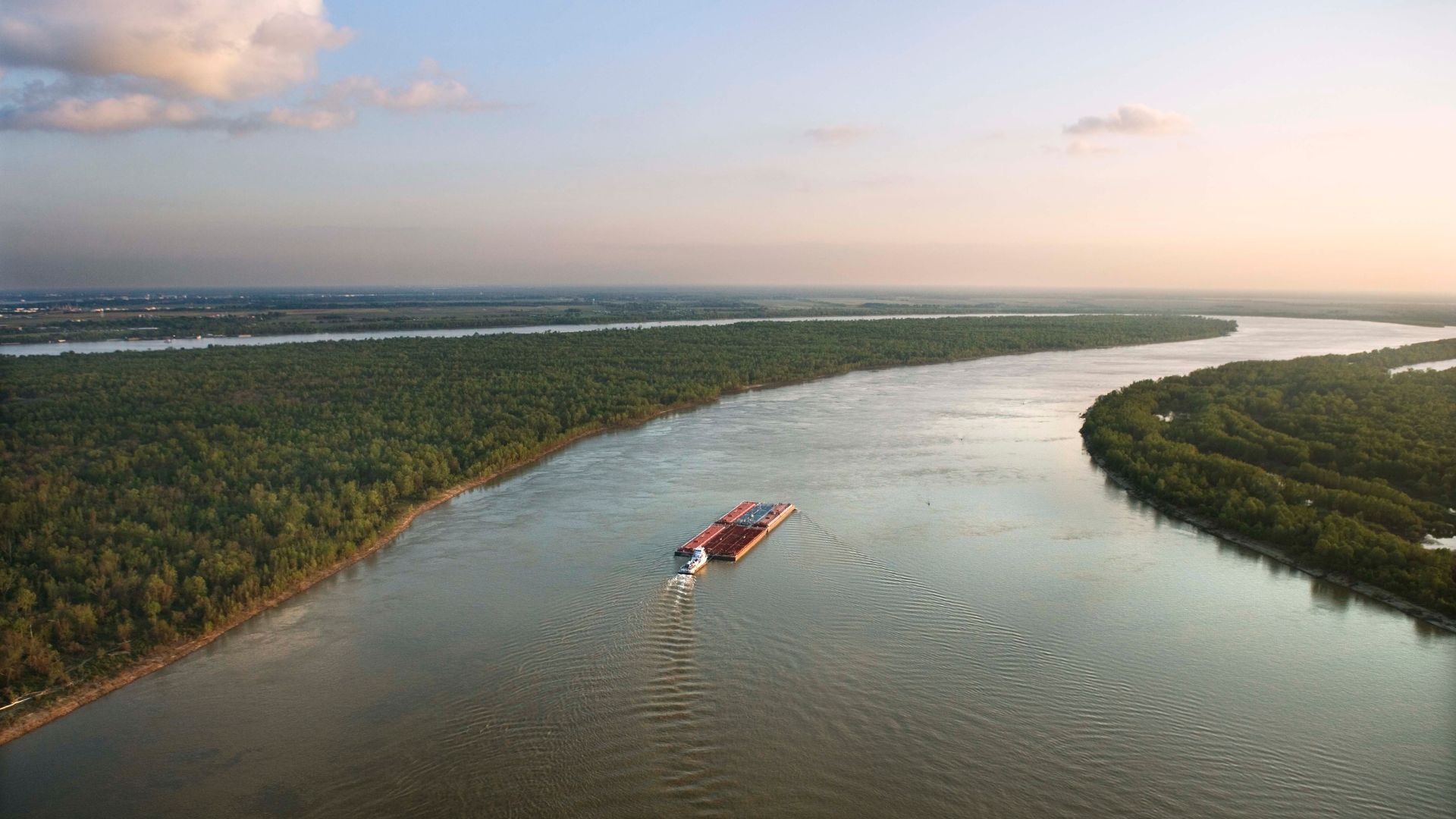 A boat cruises down a bayou in Louisiana