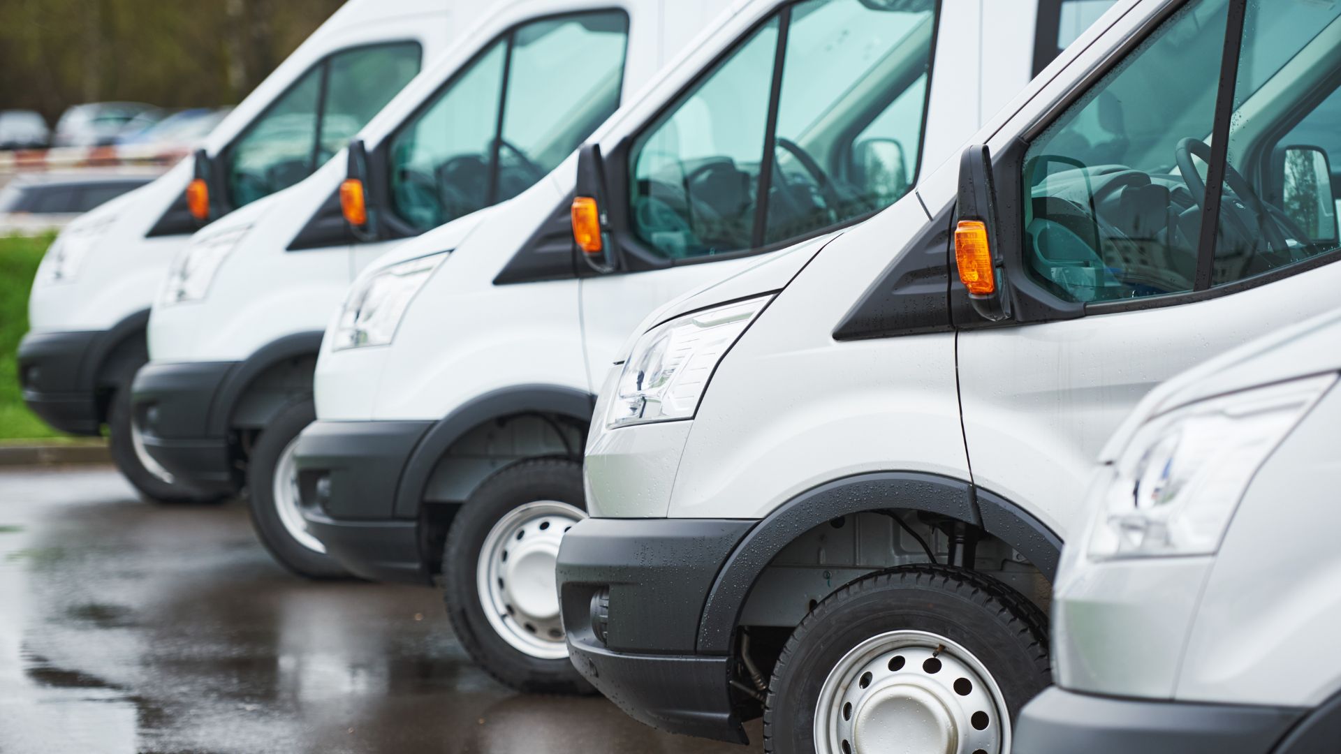 A row of white, electric delivery vans