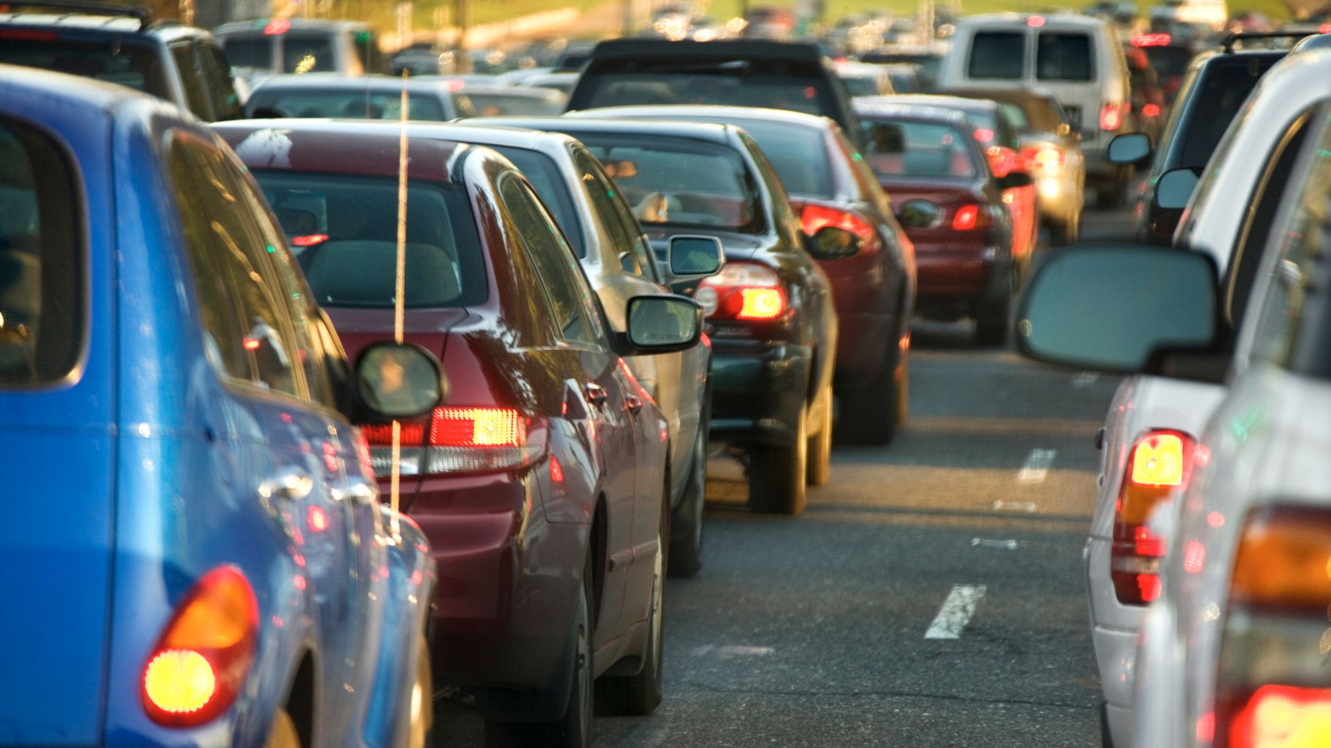 A whole bunch of cars stuck in a miserable traffic jam