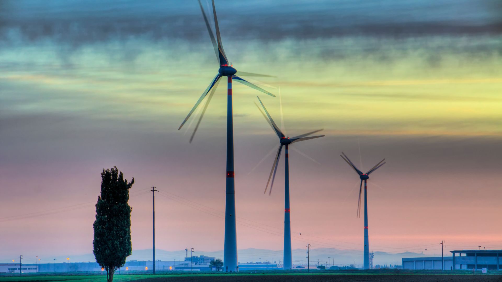 Wind turbines under the glow of the northern lights