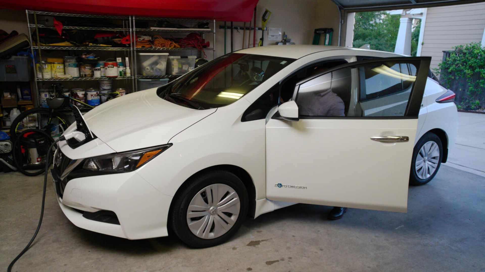 An electric vehicle plugged in inside someone's garage