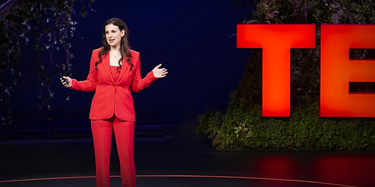 Illissa Ocko on stage giving a TED Talk about the fastest way to slow global warming