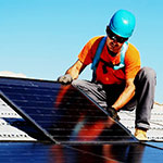 Worker installing solar panel