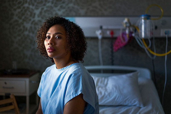 woman sitting on hospital bed