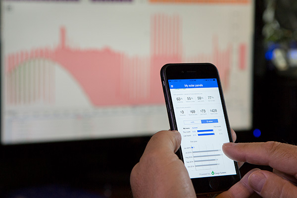 smartphone checking energy use smartphone checking energy use
