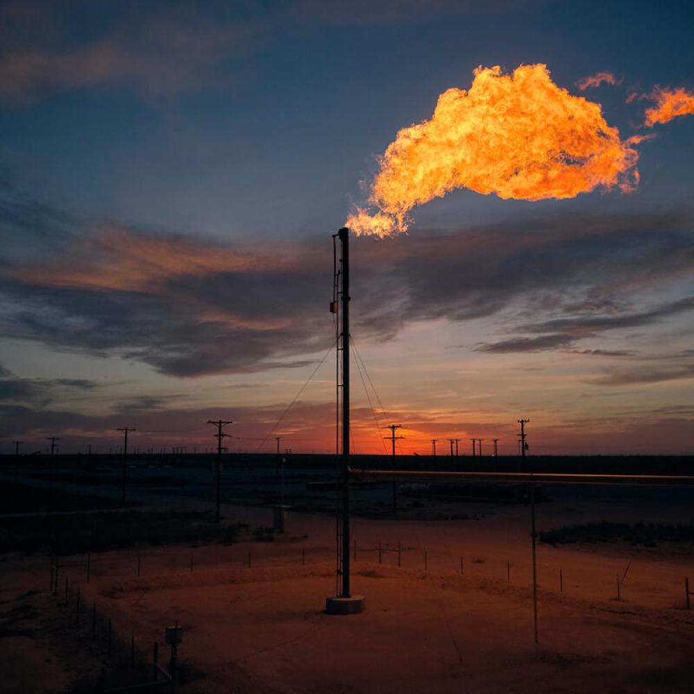 Methane flaring lights up a dark sky.