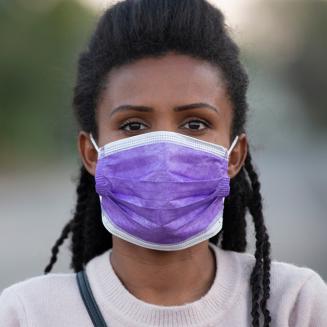Black woman wearing purple surgical mask