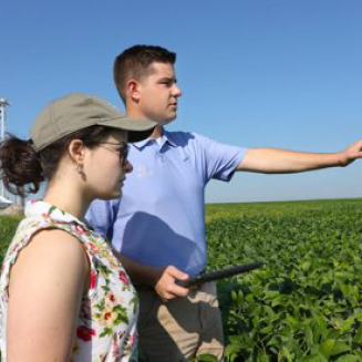 Farmer Scott Henry with unidentified woman in farm field