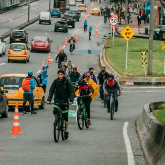 People riding bikes next to stop-and-go traffic