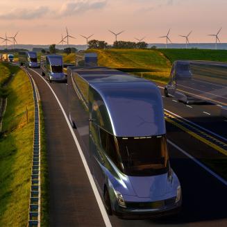 Artist's rendering of electric trucks on highway with wind turbines in background