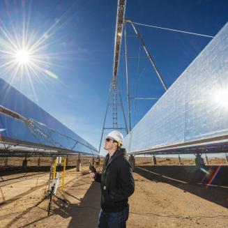 Worker looking at solar panels.
