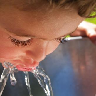 Child drinking from water fountain