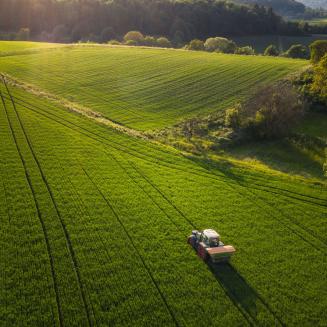 Tractor driving across farm field