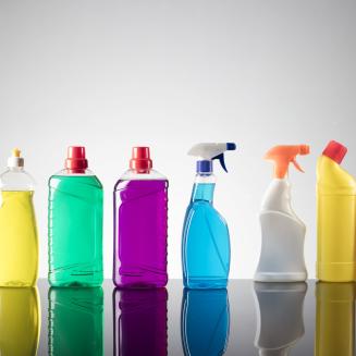 Row of multicolored plastic bottles of cleaning products