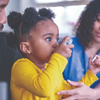 Girl at a doctor's appointment using an asthma inhaler