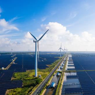 Solar power stations in plain areas, wind turbines in the distance. Yancheng City, Jiangsu Province, China