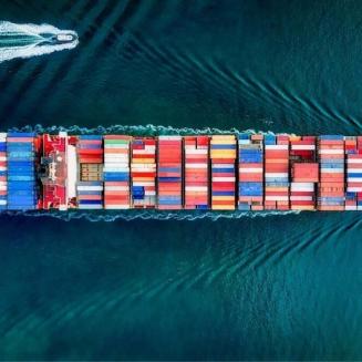 A large ship filled with shipping containers at sea