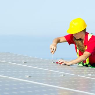 A worker installing a solar panel