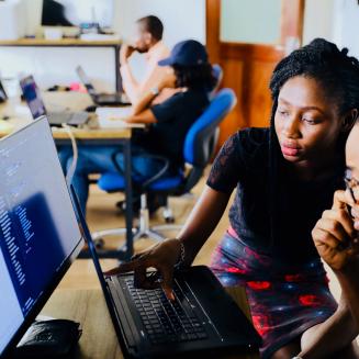 Black men and women working at computers in an office