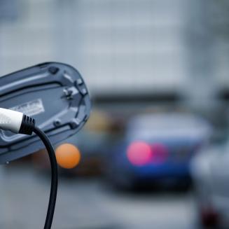 An electric car charging on the street
