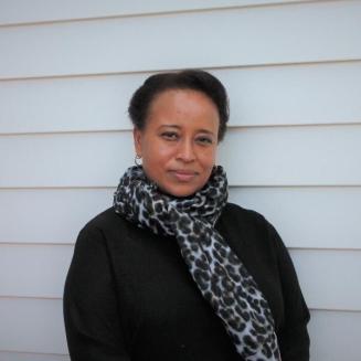 Photo of Angela Churie Kallhauge standing against a white background
