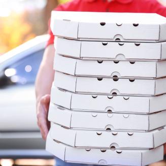 Someone holding, honestly, too many pizza boxes
