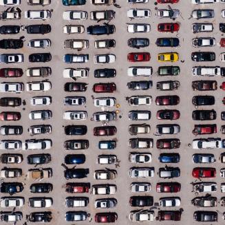 High-up overhead view of a parking lot filled with cars