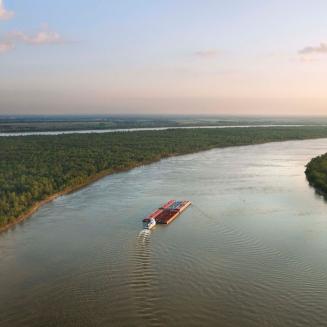 A boat cruises down a bayou in Louisiana
