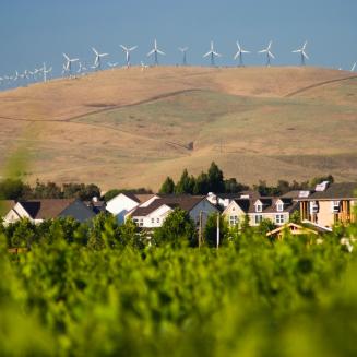 Windmills on a ridge above a neighborhood in California