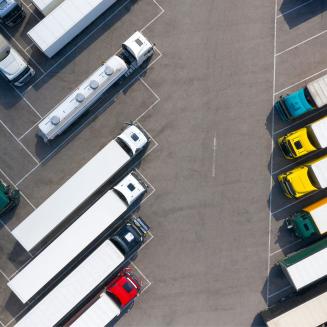 An overhead shot of a bunch of big rigs parked diagonally and really impressively straight -- like so straight and at perfect angles it feels computer generated because how could a human be this good at parking?
