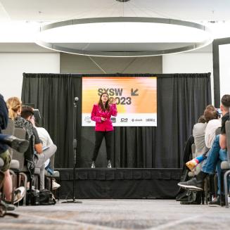A low-angle shot of Ilissa Ocko on stage at SXSW