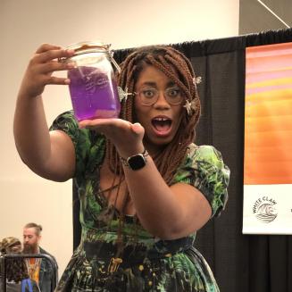 Alexis Nikole Nelson, aka the black forager, holds up a jar of purple spiderwort soda at SXSW
