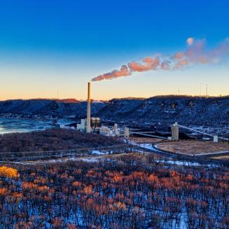 A far away shot of a billowing smokestack