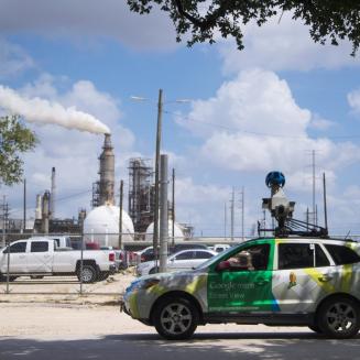 Google Street View car outfitted with air quality monitoring equipment, a dirty smokestack in the background