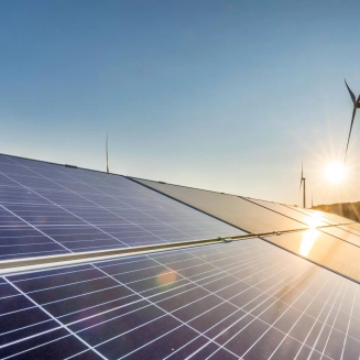 Wind and solar power stations at sunrise