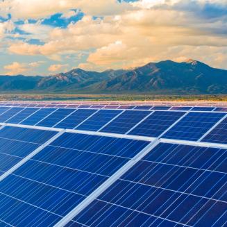 Solar panels with mountains in the background