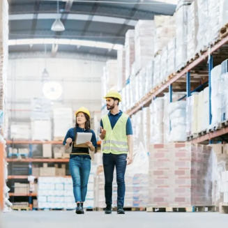 Two workers walking through a warehouse