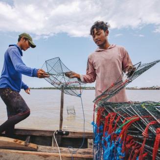 Two young men preparing traps for fishing