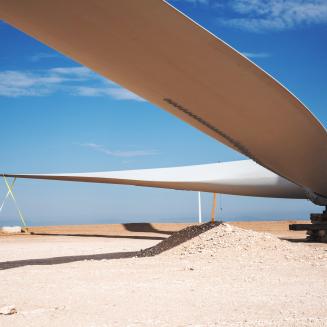Disassembled windmill on a sandy plain