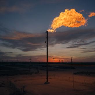Flaring at a fossil fuel facility lights up the landscape.